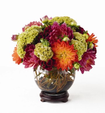 fishbowl centerpiece placed on a stained wooden stand wedding flowers and